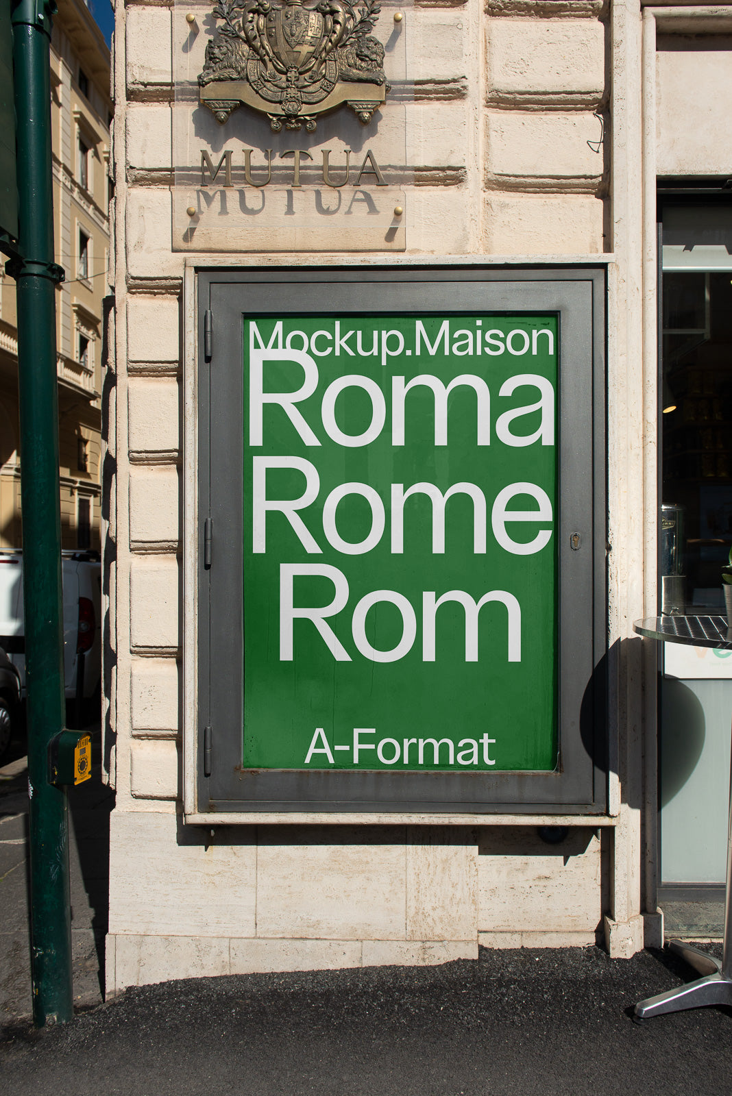 PSD mockup of a green poster on an outdoor wall, displaying the words "Mockup.Maison, Roma, Rome, Rom" in white text with a decorative crest above.