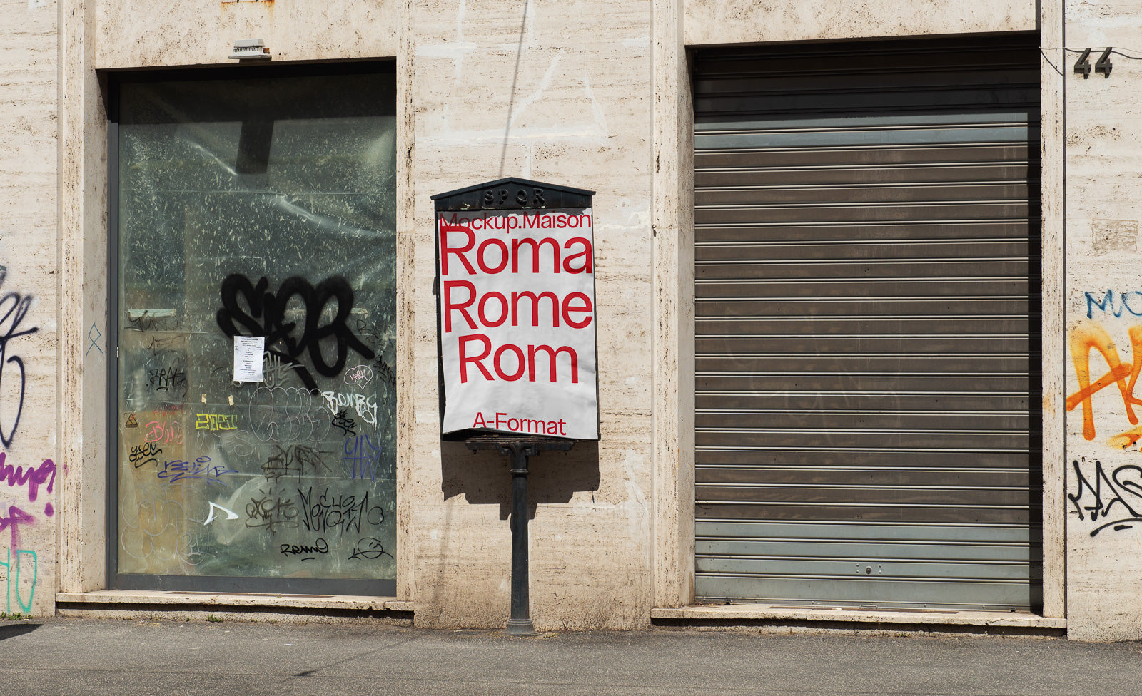 PSD mockup of an urban street scene featuring a poster with the text "Roma Rome Rom A-Format" on a building facade surrounded by graffiti.