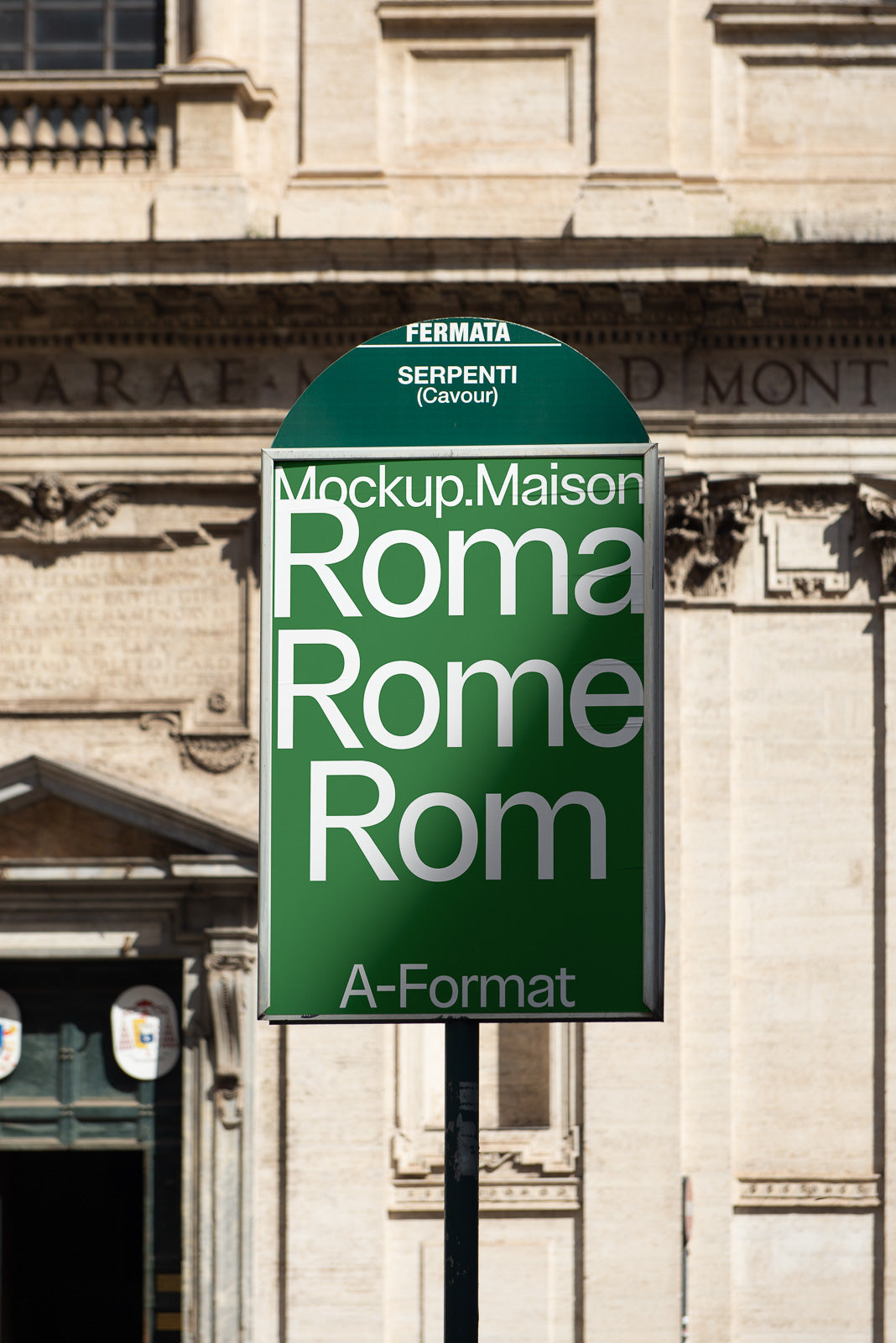 PSD mockup of a green bus stop sign in Rome with white text displaying "Mockup.Maison Roma Rome Rom." Background features a historic building facade.