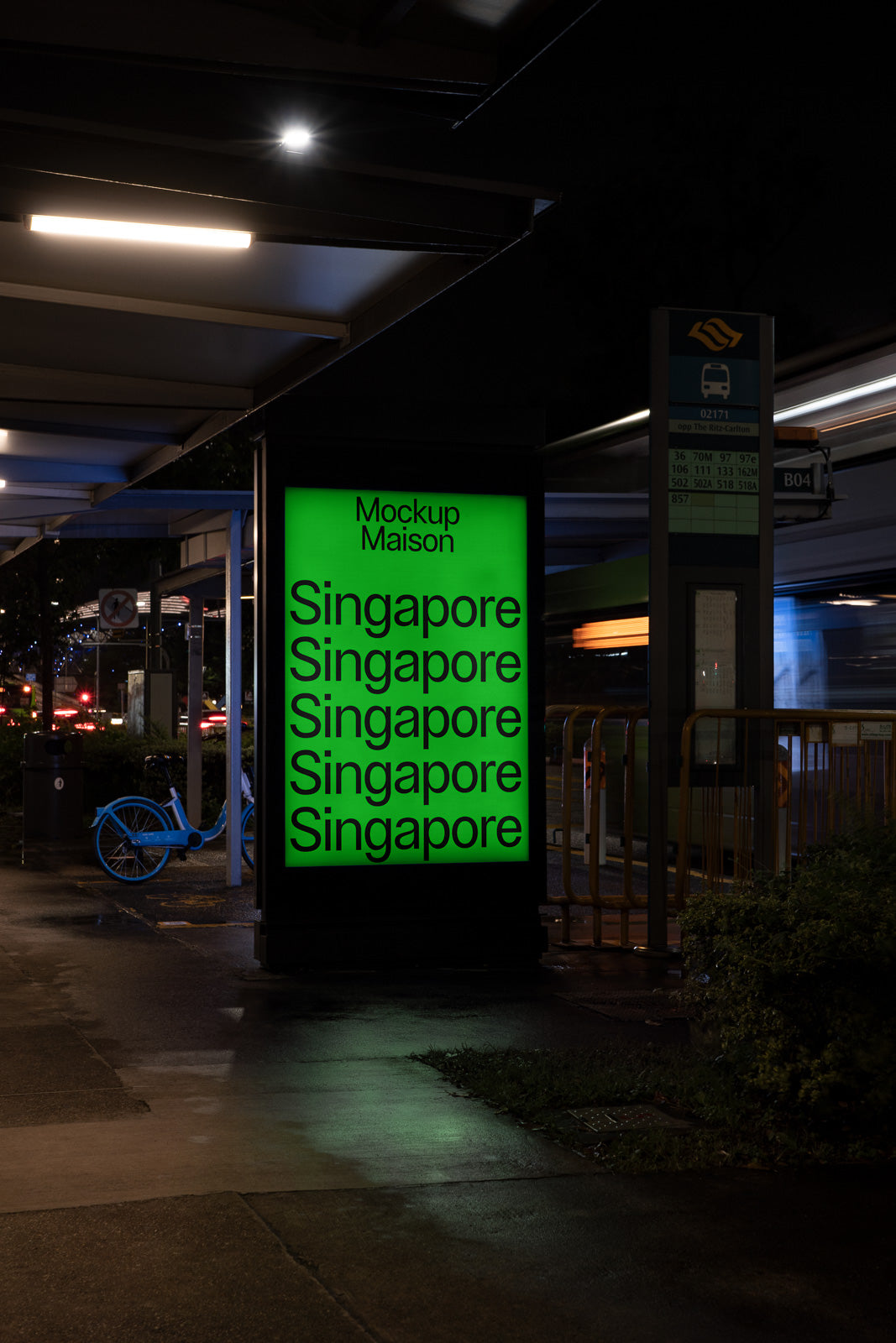 PSD mockup of an illuminated green billboard at a bus stop at night, displaying the word "Singapore" multiple times, with a parked blue bicycle nearby.