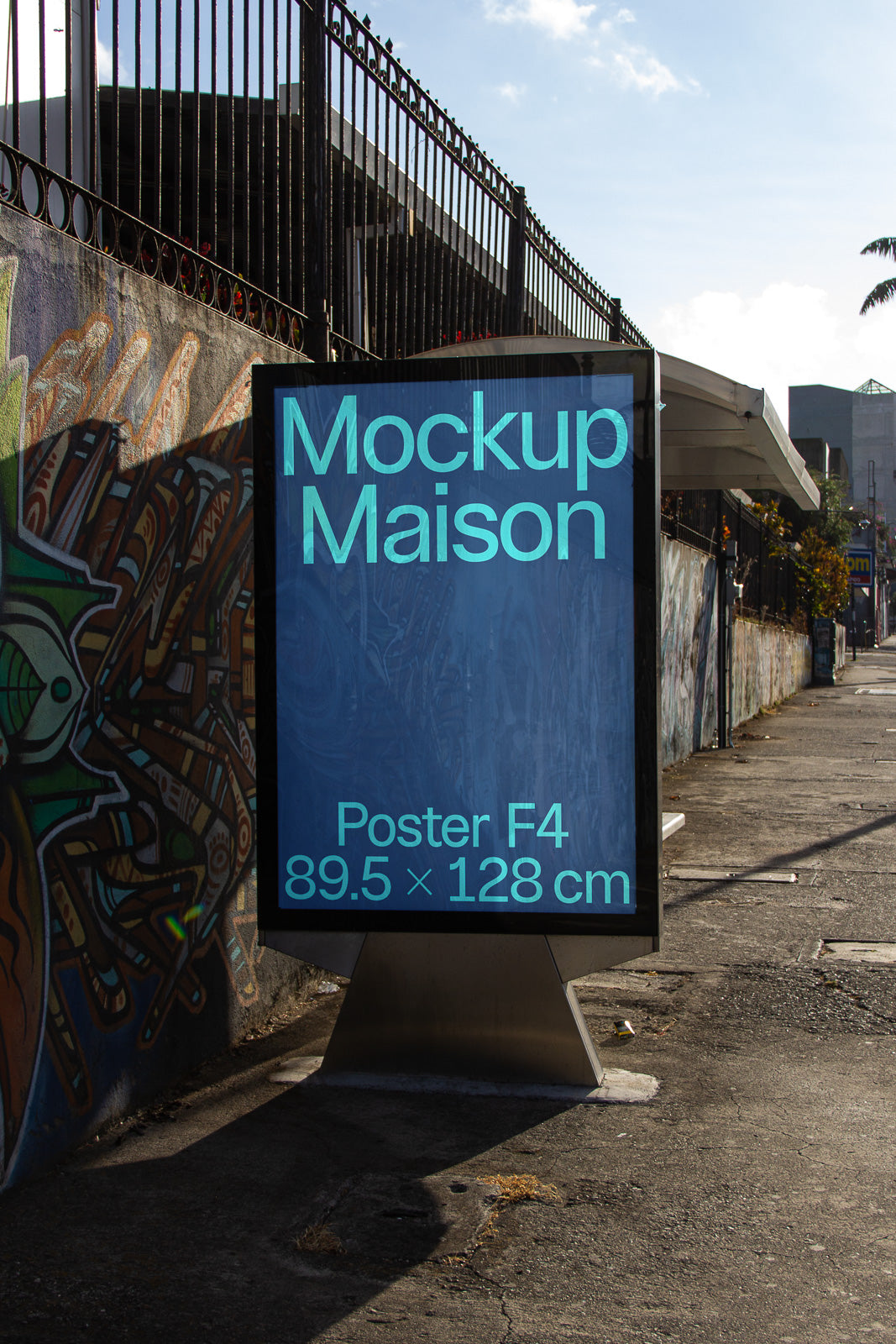 PSD mockup of a street sign displaying "Mockup Maison" and "Poster F4" with dimensions 89.5 x 128 cm against a graffiti wall.