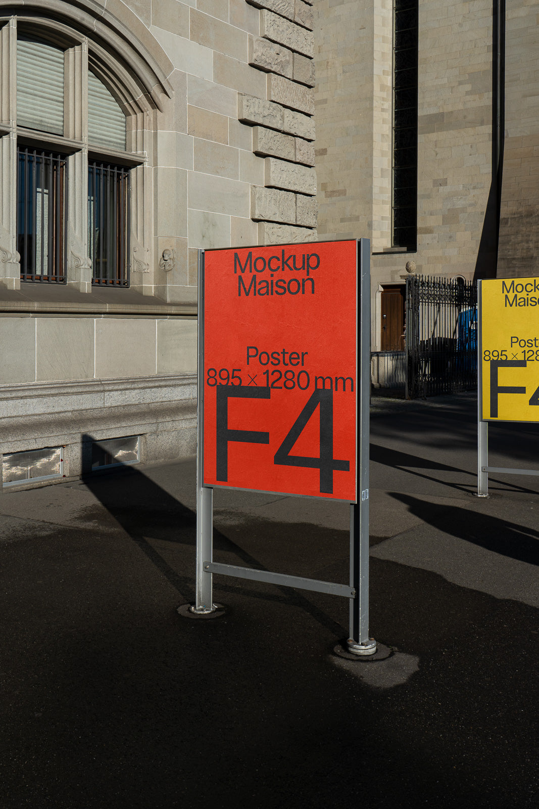 PSD mockup of an outdoor poster stand featuring a red panel with text "Mockup Maison" and "Poster 895 x 1280 mm F4", against a building backdrop.
