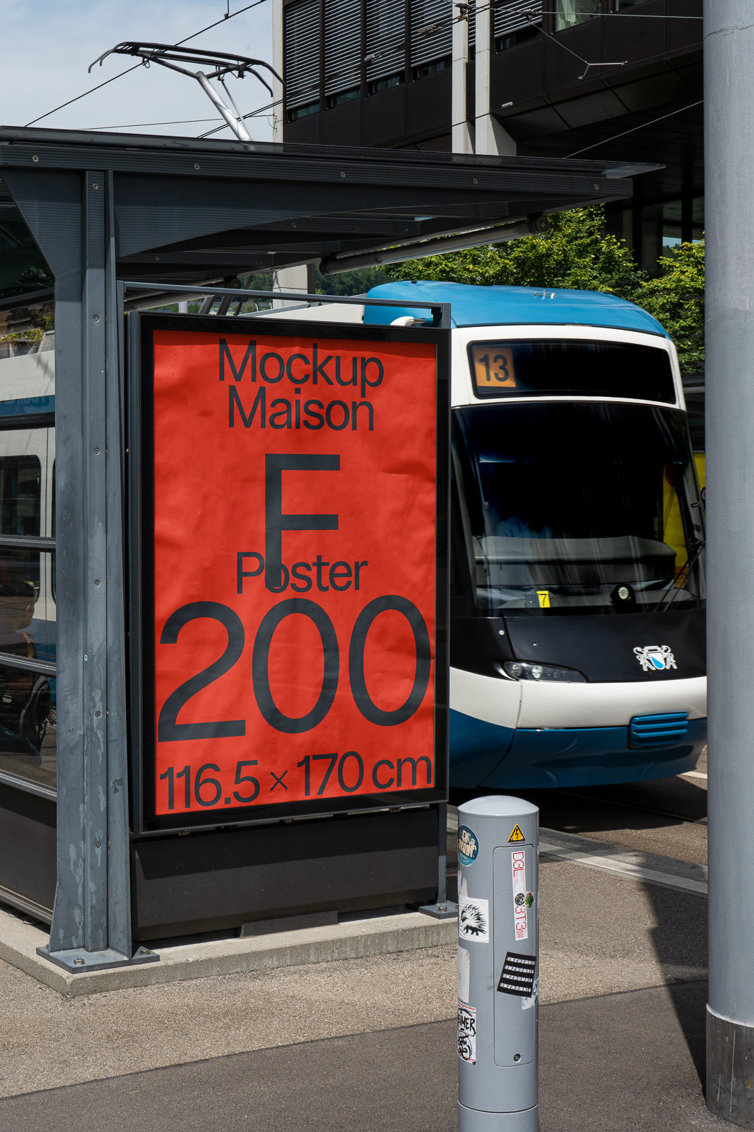 PSD mockup of a red poster at a tram station beside a blue and white tram, showcasing large black text and size dimensions.
