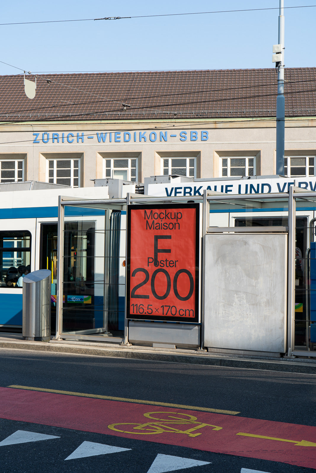 PSD mockup of a large red poster displayed at a tram stop in front of a building labeled "Zürich-Wiedikon-SBB", with dimensions 116.5 x 170 cm.
