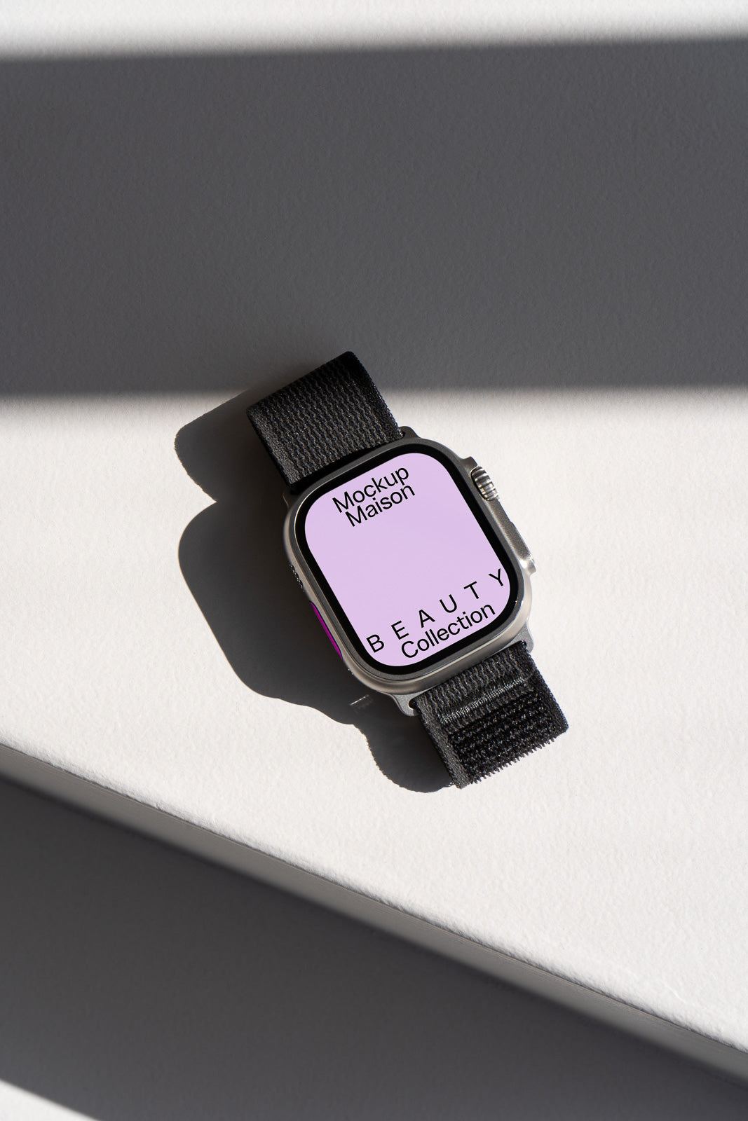 PSD mockup of a smartwatch with a black strap, displaying "Mockup Maison" and "BEAUTY Collection" on the screen, set against a light background.