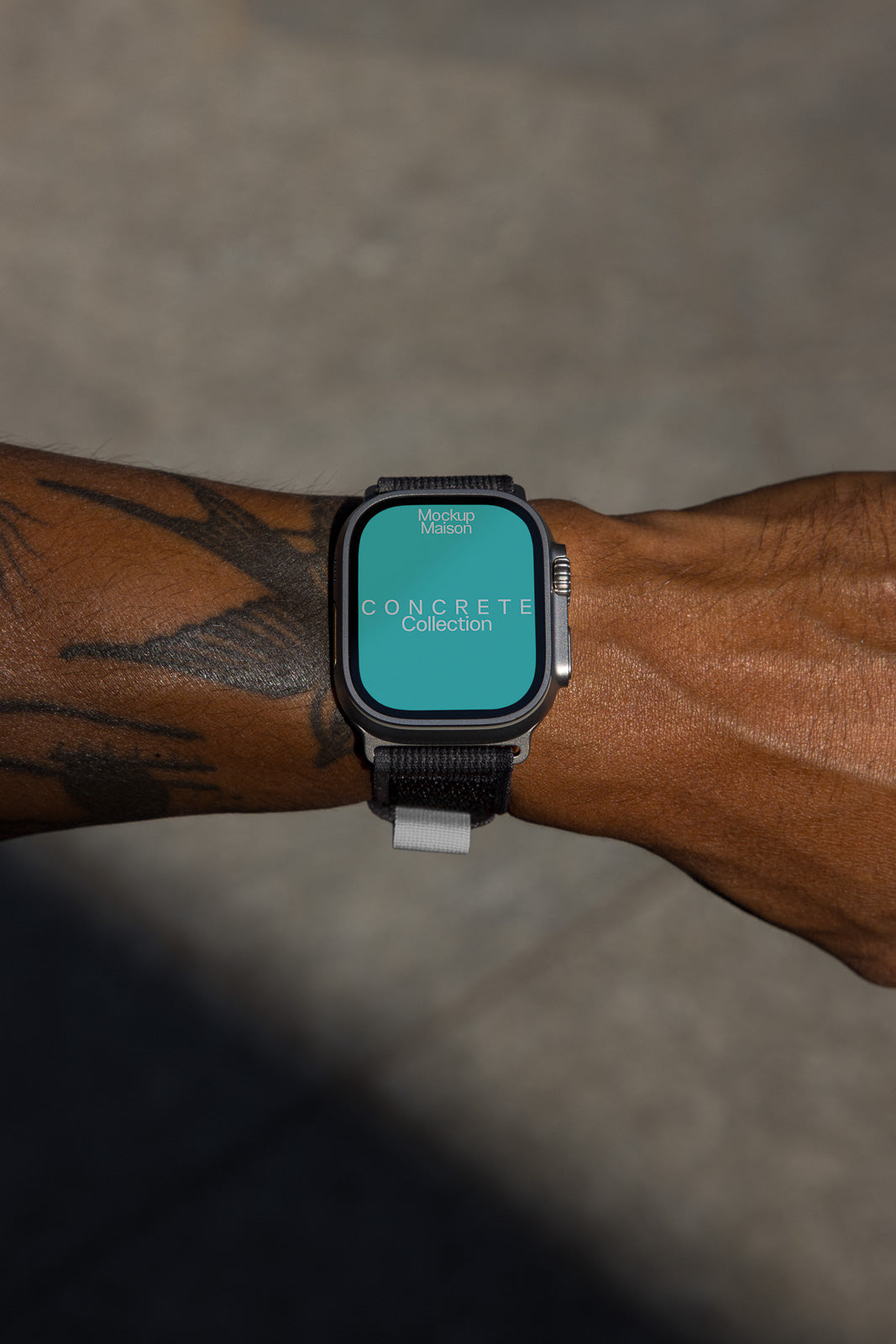 PSD mockup of a smartwatch on a tattooed wrist, displaying a turquoise screen with "Concrete Collection" text.