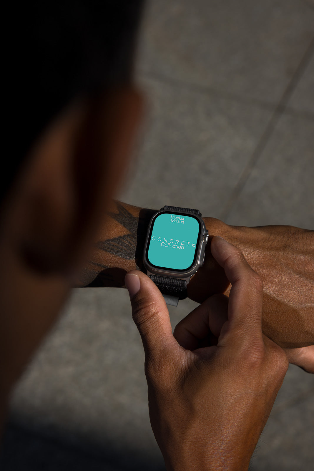 PSD mockup of a smartwatch on a person's wrist displaying the text "Concrete Collection" on the screen, highlighting modern design.