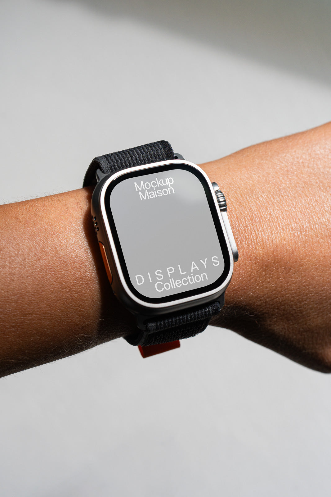 PSD mockup of a smartwatch featuring a "Mockup Maison DISPLAYS Collection" design on a wrist, highlighting its sleek and modern appearance.