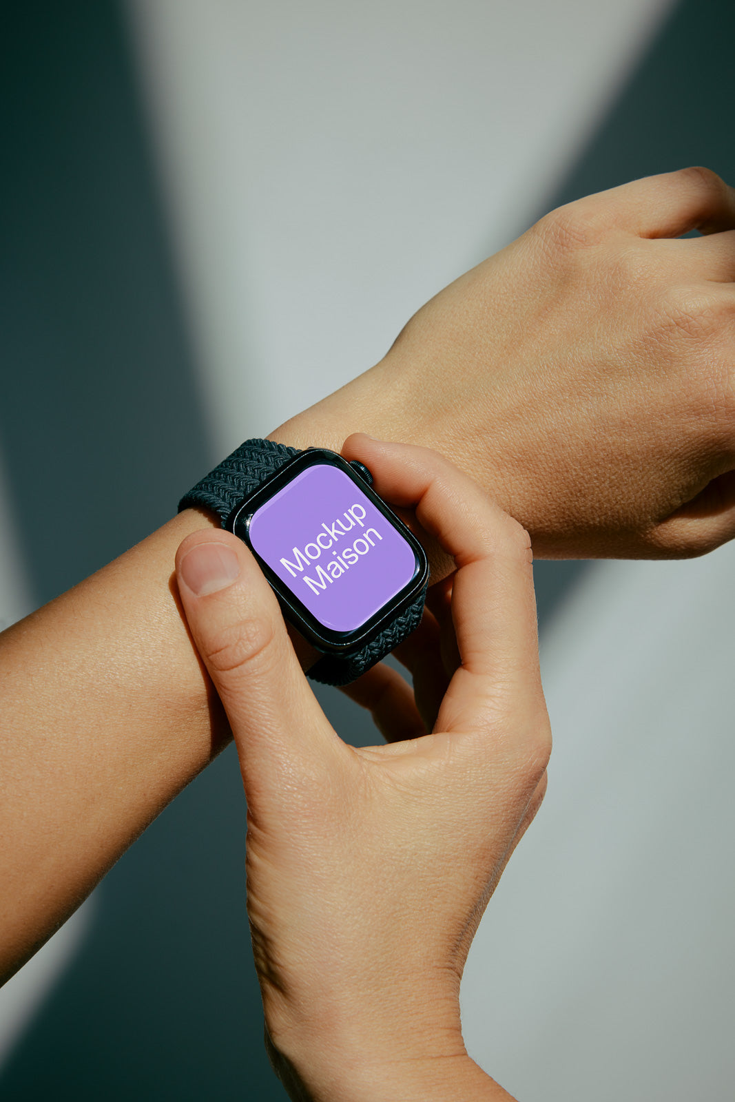 PSD mockup of a smartwatch on a person’s wrist, displaying the text "Mockup Maison" on the screen.