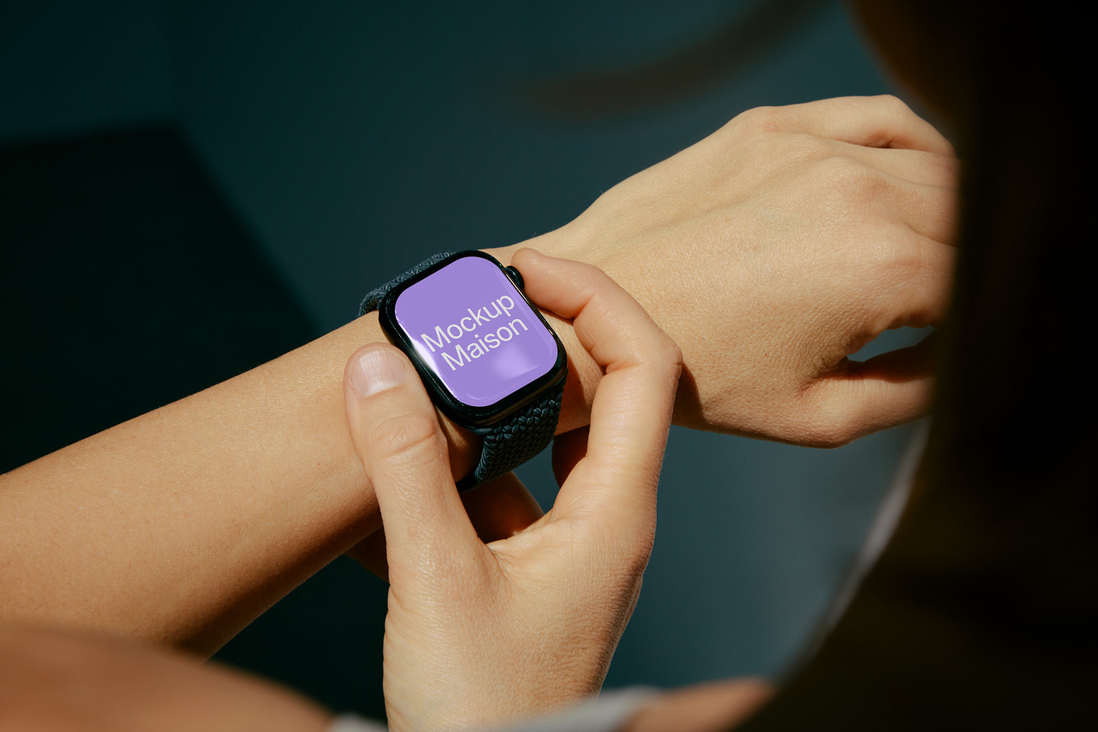 PSD mockup of a smartwatch on a person's wrist, displaying a screen with "Mockup Maison" in white text on a purple background.